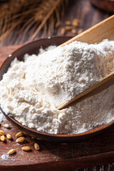 wheat flour and wheat ears on wooden table
