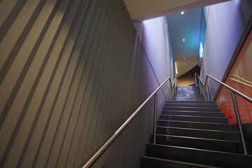 Fototapeta premium Steps lead to upper floor in a building at night