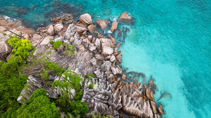 Island striking granite boulders, lush greenery, and bright turquoise waters. St Pierre Island. Seychelles.
