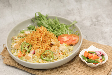 Indonesian Nasi Goreng Ayam with Crispy Toppings and Fresh Vegetables