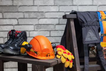 Work safety protection equipment on wall background with place for text.
