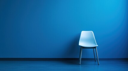 A blue chair against a blue wall in a room with a blue floor.