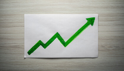 Financial Growth Line Drawing. Financial Planning, Budgeting, and Forecasting. a generic white paper with a bold upward-sweeping line graph hand-drawn in green marker set on a simple wooden surface.
