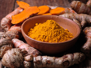 Turmeric powder in a wooden cup
