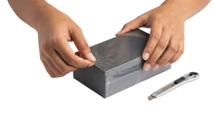 Hands peeling plastic film off rectangular box isolated photo