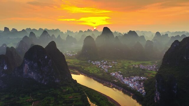 Aerial shot of spectacular karst mountain with river and village landscape at sunset in Guilin, China. 