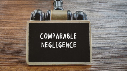 Comparable Negligence Legal Concept on Chalkboard with Gavel on Wooden Background