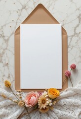 Elegant blank white card in open kraft envelope with vintage dried flowers and lace on marble, ideal for wedding or greeting invitations
