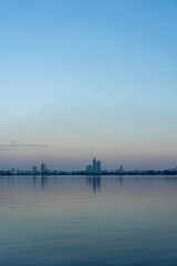Fototapeta premium Hanoi Skyline Reflected on Ho Tay, West Lake at Sunset, Vietnam