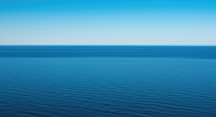 Obraz premium A peaceful view across a massive, blue expanse of water stretching out to the distant horizon under a clear sky ,clear ,marine ,vacation