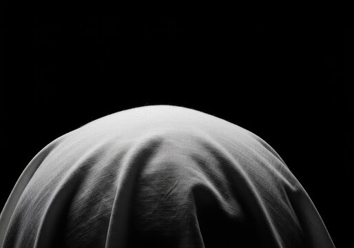 Close-up view of the distinctive white head covering associated with high religious office, emphasizing texture, purity, and bright illumination ,zucchetto ,spiritual ,clothing