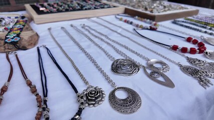Jewelry display at market with various designs and styles