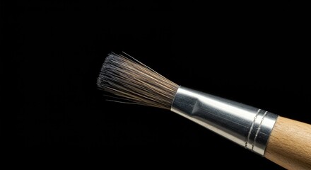 Close-up showing the fine bristles and wooden handle of a specialized, professional tool used for detailed painting and artistic creation ,creation ,quality ,creative