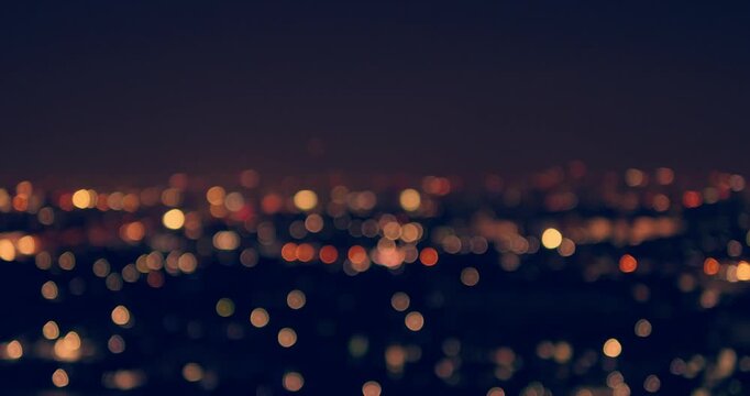 A mesmerizing view of a cityscape illuminated by vibrant bokeh lights at night capturing urban beauty.
