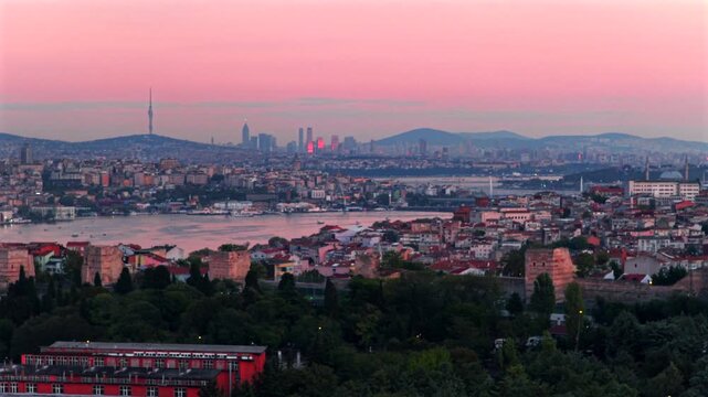 Bosphorus Strait ferry boats harbor view sunset golden hour pink purple sky afterglow Istanbul Turkey T&uuml;rkiye aerial drone panoramic landscape cityscape buildings city skyscrapers static shot