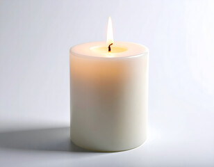 A brightly lit, unscented white pillar candle standing on a plain surface with a gentle glow
