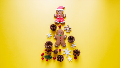 Merry Christmas festive arrangement with gingerbread men, pinecones, and snowflakes on a bright yellow background, forming a Christmas tree shape.