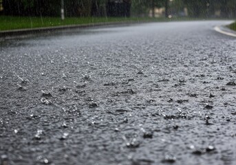 Heavy downpour during the day striking a wet asphalt road, creating reflections and ripples. The sky is overcast, but the daylight illuminates the water flow ,daytime ,blurred ,runoff