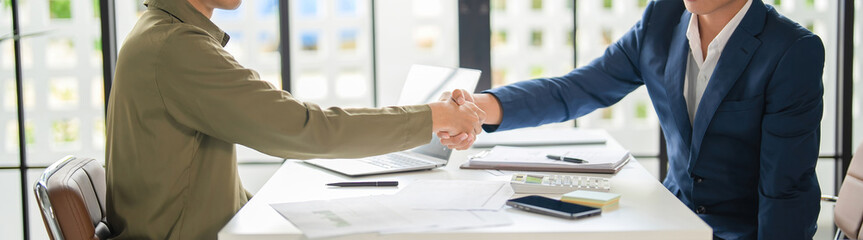 Businessmen shaking hands in agreement.