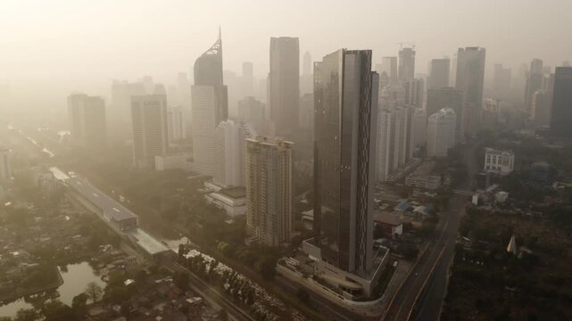 Hazy Aerial View of Jakarta's SCBD High-Rises and Mass Transit
