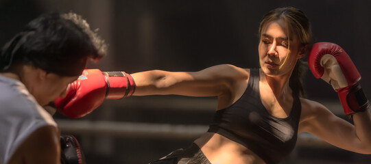 Muaythai boxer woman training Thai boxing with male trainer