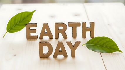 Earth day message with cardboard letters and green leaves on wood.