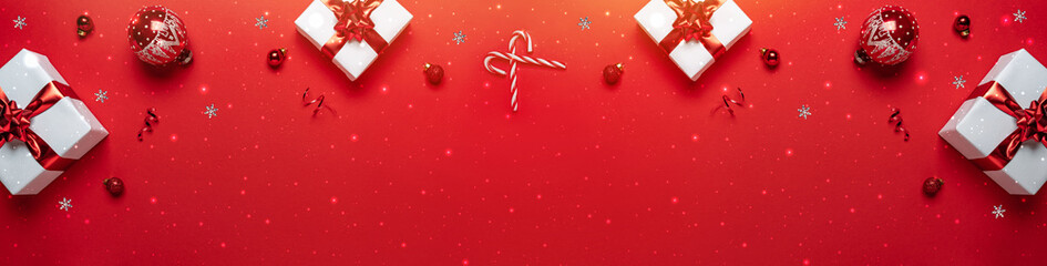 Merry Christmas and Happy New Year greeting card. Christmas gifts with red glitter decorations on...