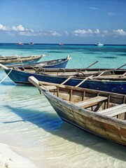 Obraz premium Picturesque wooden boats line the turquoise shoreline of a tranquil Zanzibari beach
