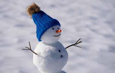 Snow man for winter holiday card background. Snowman outdoors in snow. Snowman for festive winter poster. Snowman with scarf outdoors in winter. Snowman for Christmas greeting card.