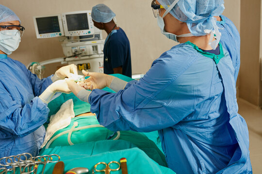 Emergency room, surgery and people with medical tools for procedure, instrument preparation and ppe. Healthcare, surgeon and nurses cleaning equipment for operation, safety standard and collaboration - Powered by Adobe