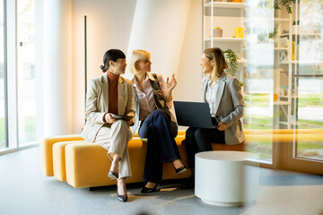 Business professionals discuss ideas in a modern office lounge setting