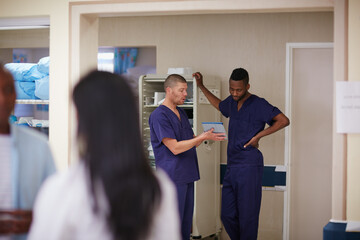 Tablet, men and surgeon team with discussion for healthcare, history and training in meeting....