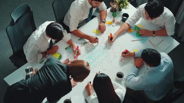 Top view of professional business team working together to brainstorm environmental idea by using mind map. Aerial view of smart manager talking and discussing about sustainable energy. Alimentation.