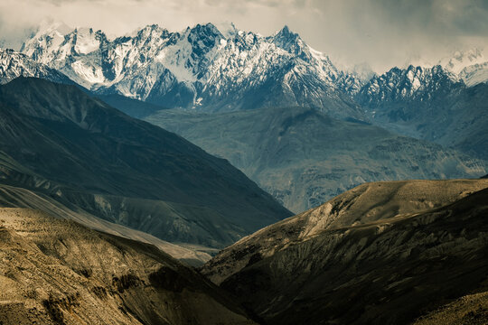 Aerial of the Wakhan Corridor in Afghanistan Tajikistan border , rugged Pamir Hindu Kush mountains, winding glacial rivers and remote high altitude valleys
