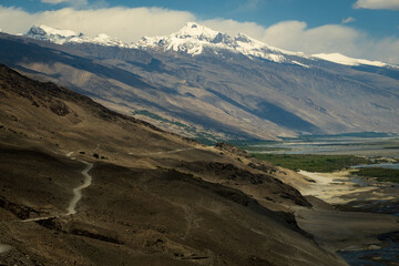 Aerial of the Wakhan Corridor in Afghanistan Tajikistan border , rugged Pamir Hindu Kush mountains, winding glacial rivers and remote high altitude valleys