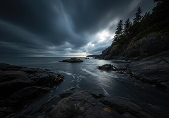 A moody, tranquil coastal landscape featuring dark water washing onto a rugged shore beneath an expansive, overcast sky ,wilderness ,serene ,rugged