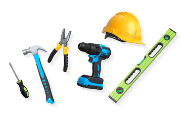 Collection of construction tools, helmets, and safety gear on white background, symbolizing work safety and building industry