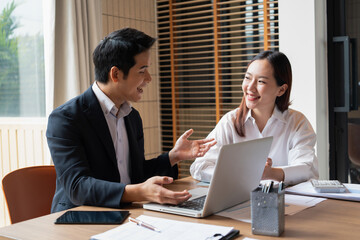 Businessmen working together using laptop