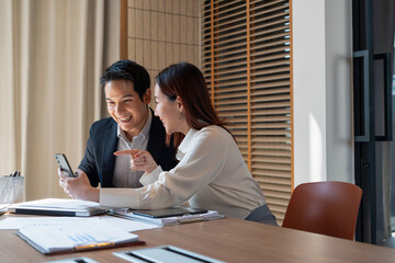 Businessmen celebrate news in smartphone