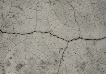 Obraz premium Detailed view of a weathered gray concrete surface, exhibiting deep cracks and a rough, natural stone appearance. Ideal abstract background ,grey ,structure ,modern