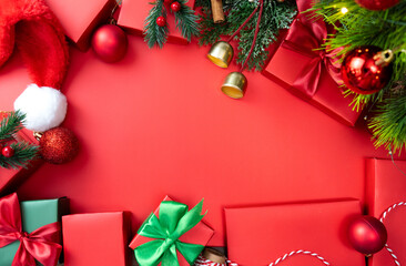 Festive red background with Christmas ornaments and gift boxes, holiday design for Christmas and New Year