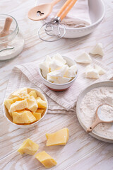 Assorted cocoa butter with baking ingredients on wooden table