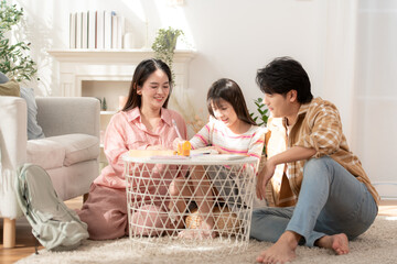 A family helping their daughter with arts and learning activities