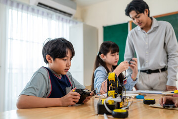 Group of students learning in a robotics class at elementary school.