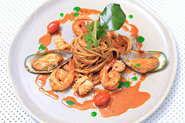 Spaghetti Tom Yum Seafood, Thai style fusion food, spicy pasta with squid, shrimp, new zealand mussels in tom yum sauce