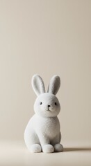 Obraz premium A white and fluffy bunny figurine sitting peacefully on a light background, emphasizing texture, softness, and purity ,small ,purity ,figurine