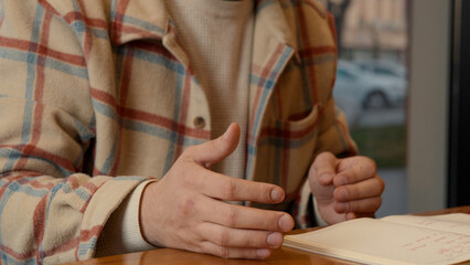 Close-up of mentor explaining details to the female colleague student