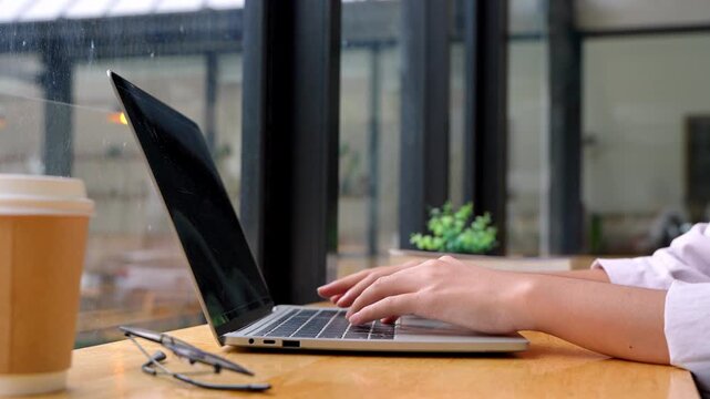 Typing on laptop at home office work environment desktop setup modern space close-up view for productivity