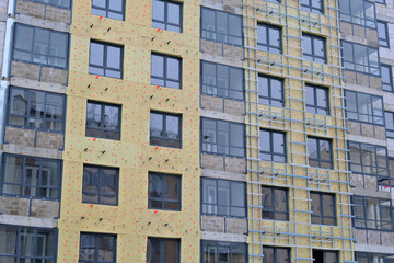 Building facade renovation showing insulation and windows installation