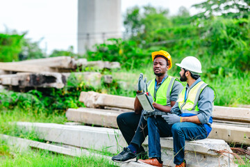 Railway engineer and technician inspecting concrete pier sections and construction debris
